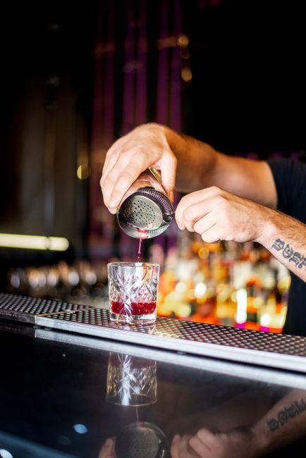 Close-up of a bartender pouring a cocktail at a trendy bar in Kyiv, Ukraine. Perfect for lifestyle and nightlife themes. Close-up of a bartender pouring a cocktail at a trendy bar in Kyiv, Ukraine. Perfect for lifestyle and nightlife themes.