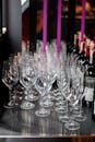 Wine glasses on a counter with purple ribbons