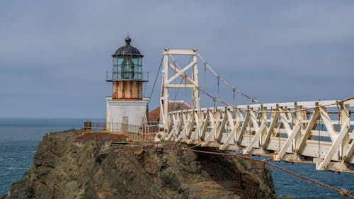 A lighthouse on a bridge over water