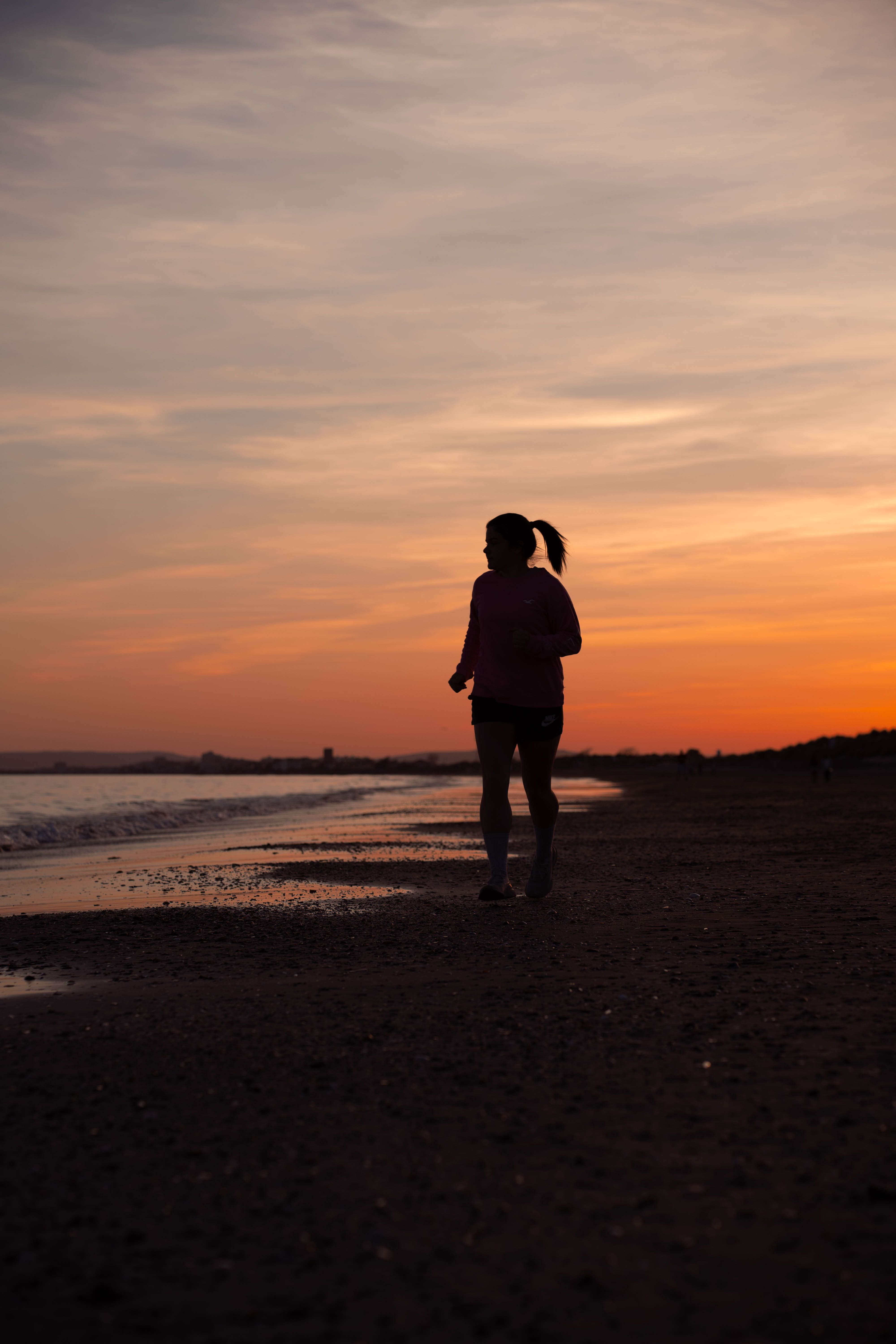 Silhouette of Woman Running on Beach at Sunset · Free Stock Photo