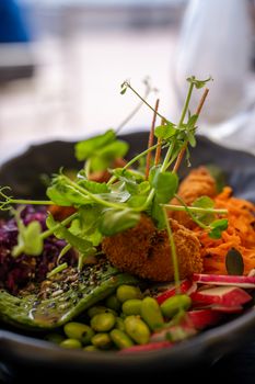 A colorful vegetarian salad bowl featuring fresh greens, veggies, and crispy elements for a healthy meal.