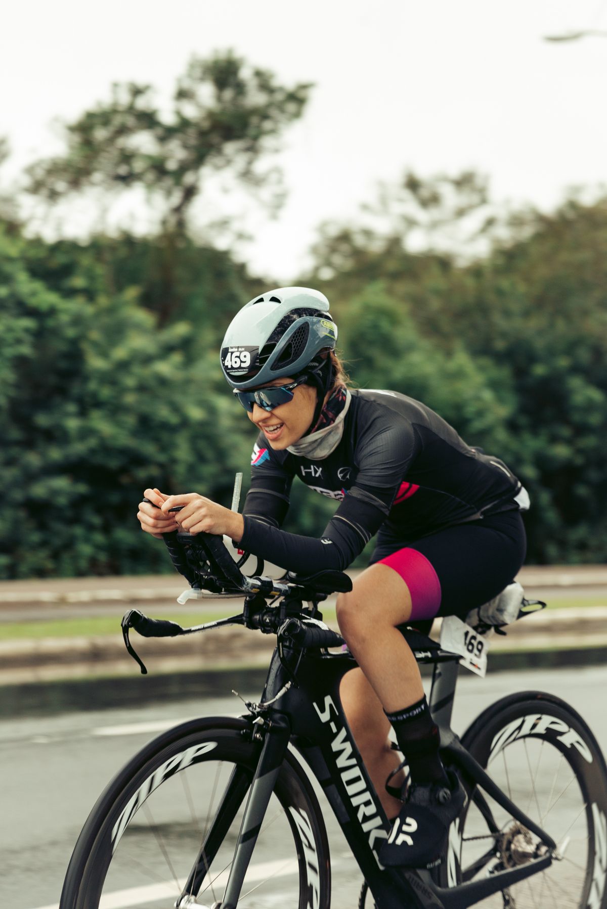 Helmeted cyclist riding confidently through a city street