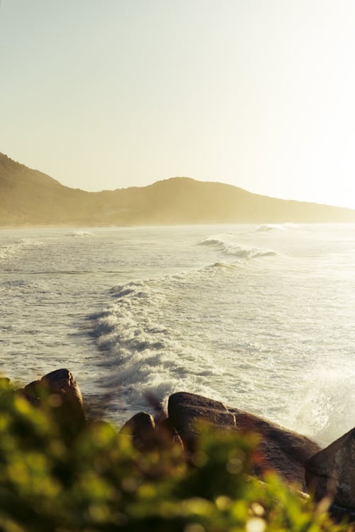 A surfer is riding waves on the beach