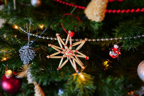 Free Close-up of a Christmas tree adorned with handmade ornaments and twinkling lights. Stock Photo