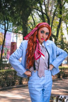 Stylish woman in blue suit posing outdoors in a park in Ciudad de México.