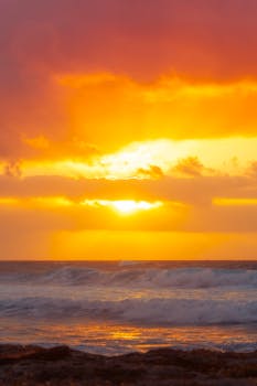 A stunning sunset painting the ocean with warm hues, capturing the essence of tranquility and beauty.