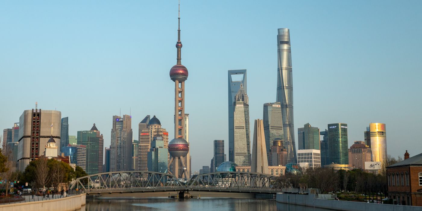 Shanghai skyline at dusk with the Oriental Pearl Tower, where median August hotel rates run about 88 US dollars