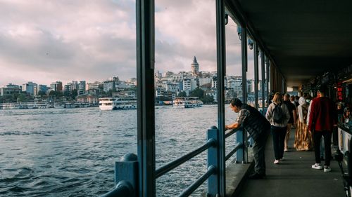 Free Bustling scene on the waterfront by Galata Bridge in Istanbul, with the iconic Galata Tower and waterways. Stock Photo