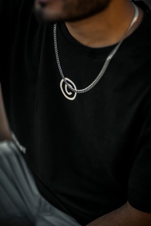 Free Close-up portrait of a man wearing a black t-shirt and silver chain. Stock Photo