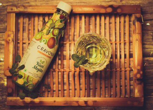 Free Top view of a Kiwi Mojito bottle and glass with mint on a bamboo tray. Stock Photo