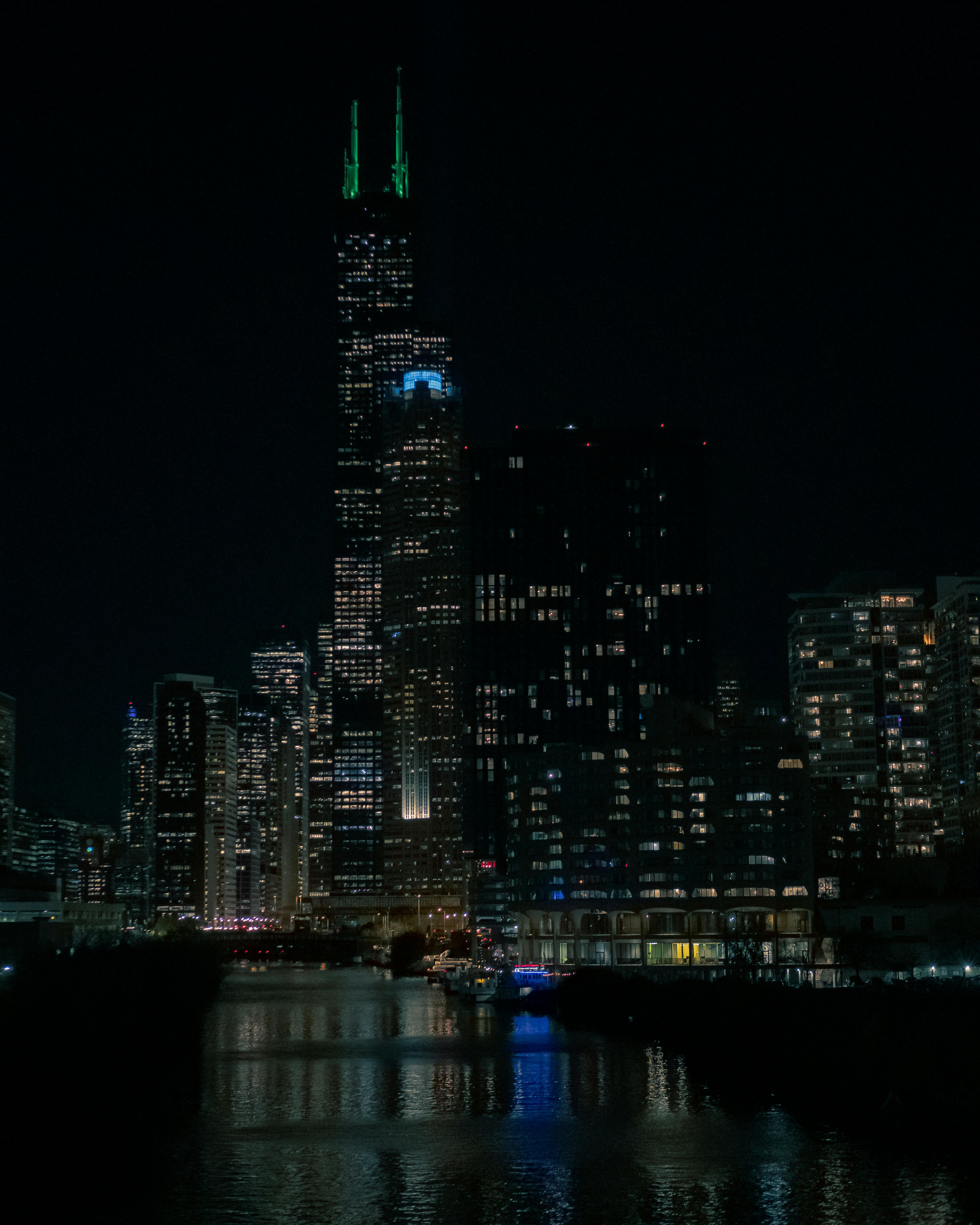 Stunning night view of Chicago skyline with iconic Willis Tower lit up uniquely.