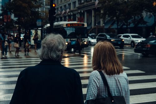 Free Busy Chicago intersection with pedestrians and traffic captured from behind. Stock Photo