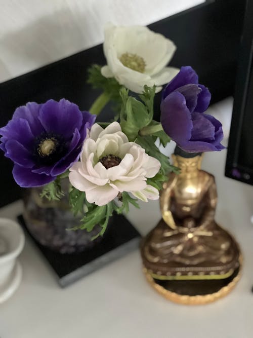 An arrangement of purple and white flowers on a desk