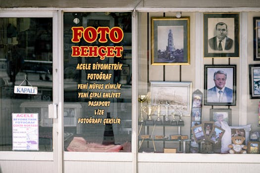 Front view of a photography studio with framed portraits and trophies.