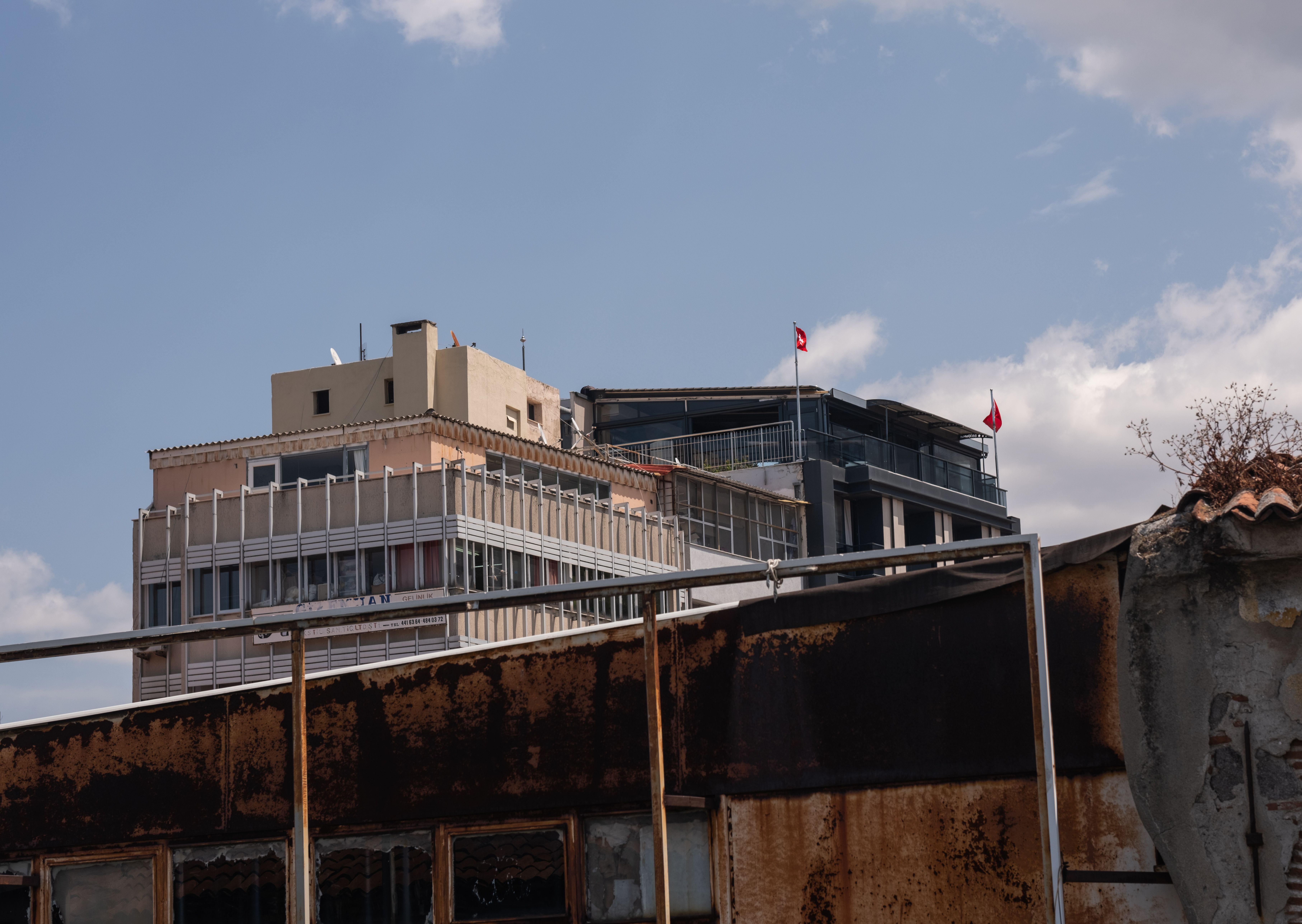 Buildings behind Wall and Bar · Free Stock Photo