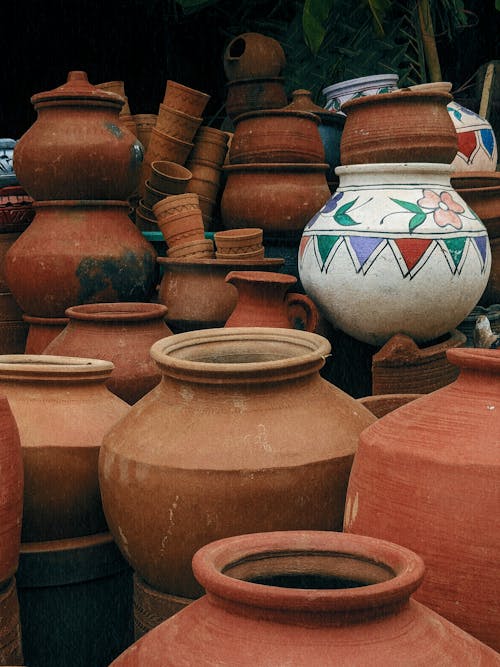 A pile of clay pots and jars sitting on a table