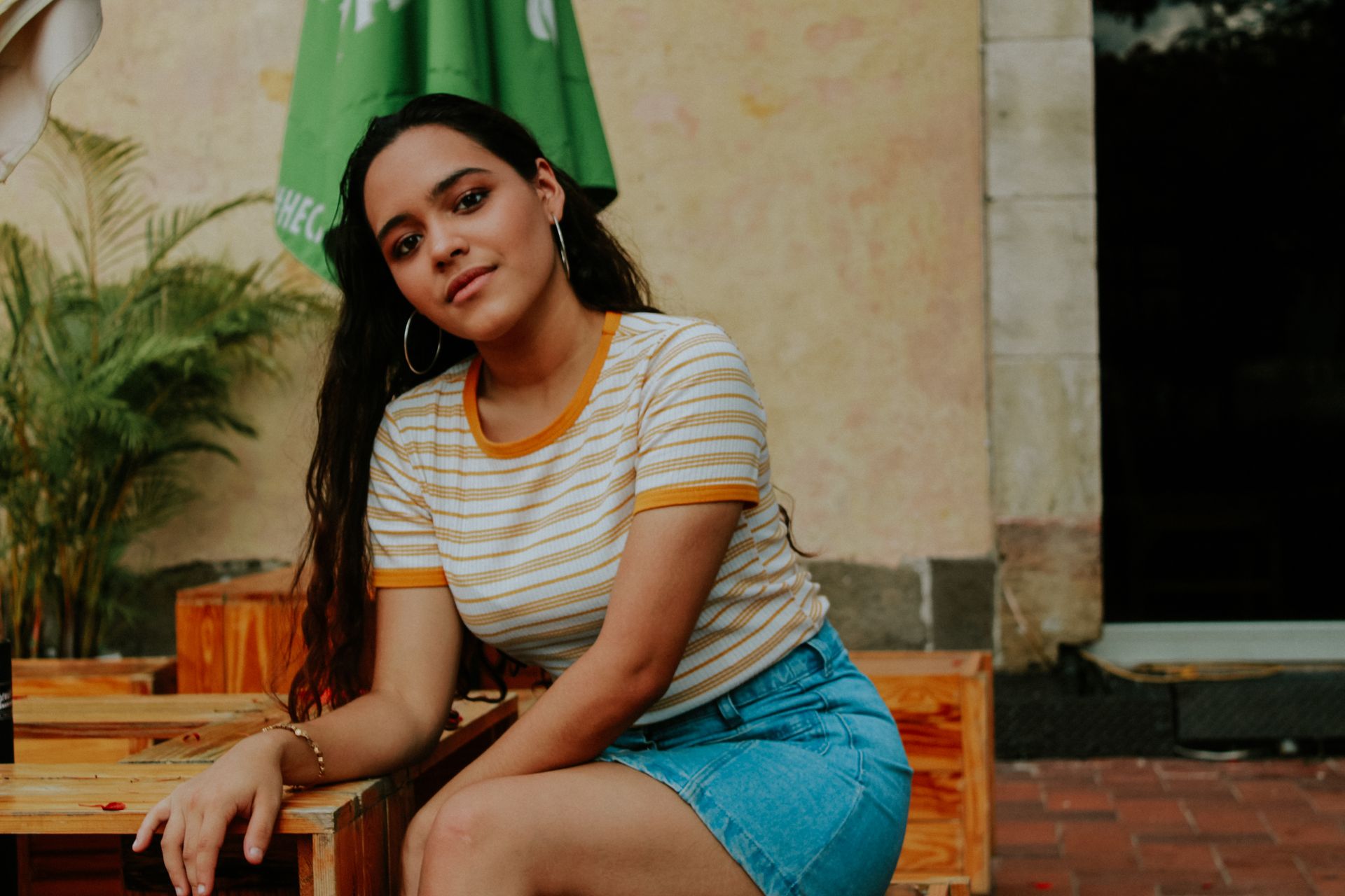 Portrait of a young Hispanic woman sitting casually in Panama City.