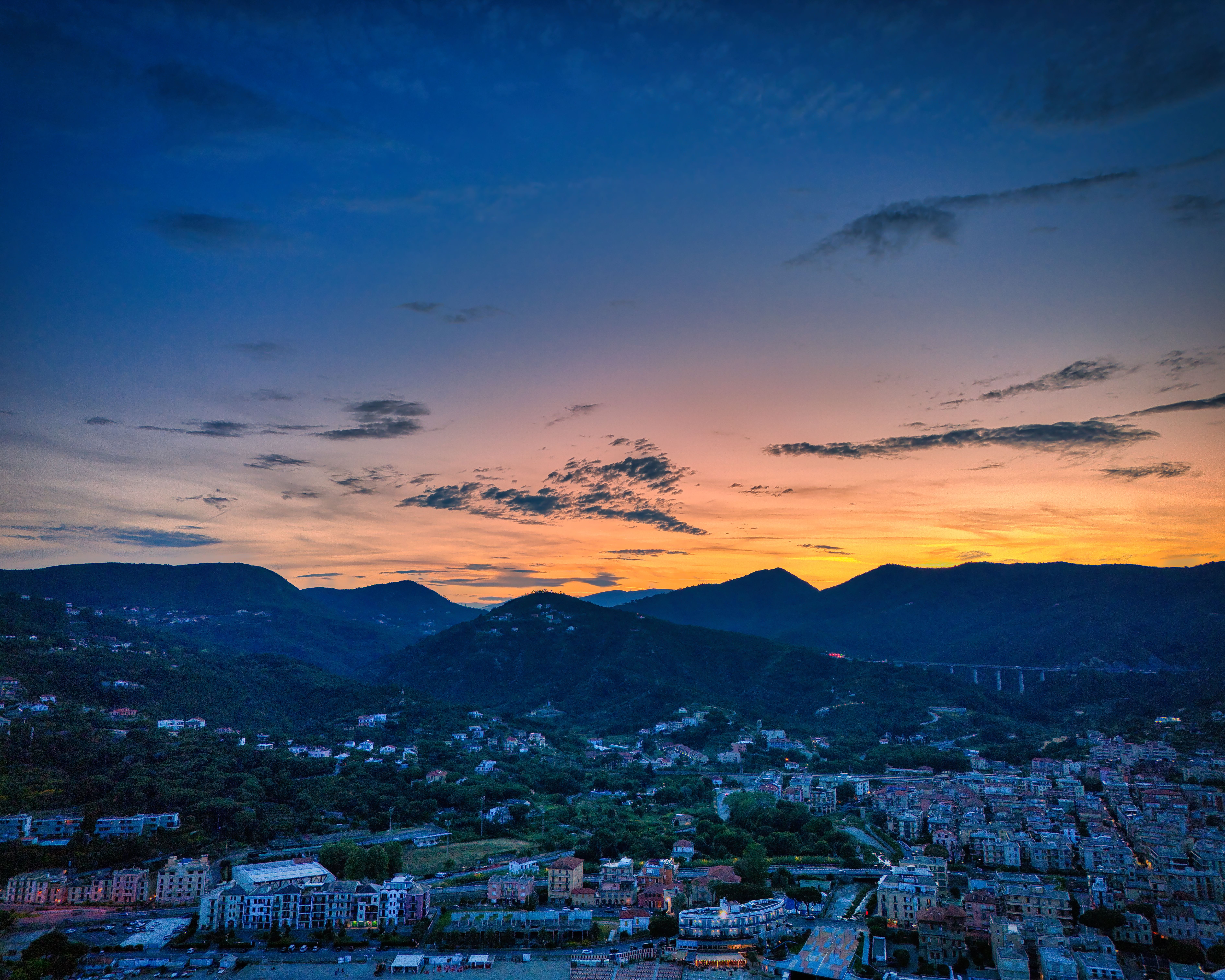 Landscape of a City by the Mountains in the Sunset · Free Stock Photo