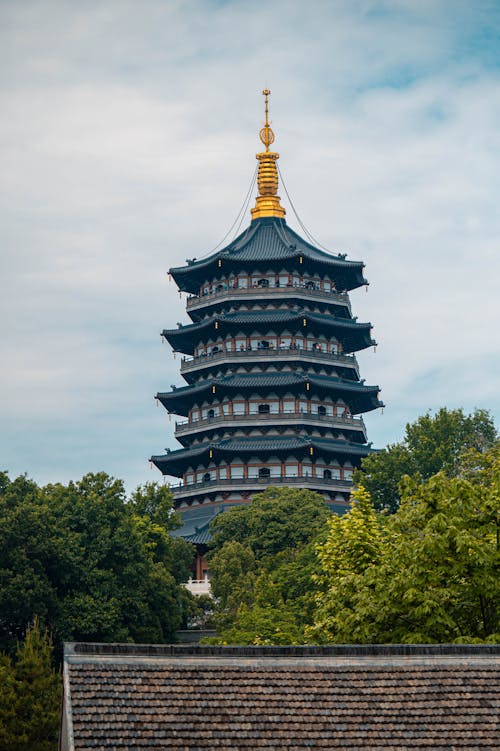 A pagoda with a gold roof and a green roof