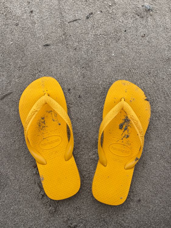 Top View of Yellow Flip Flops on Sand · Free Stock Photo