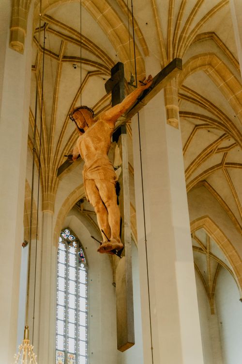 Free Low-angle view of a crucifixion statue in a historic Munich church. Stock Photo