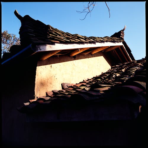 A roof with a tiled roof and a chimney