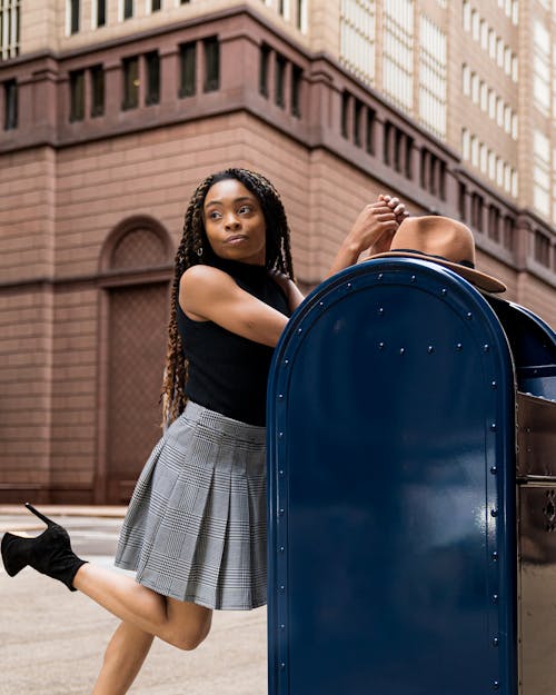Woman Posing next to Mailbox
