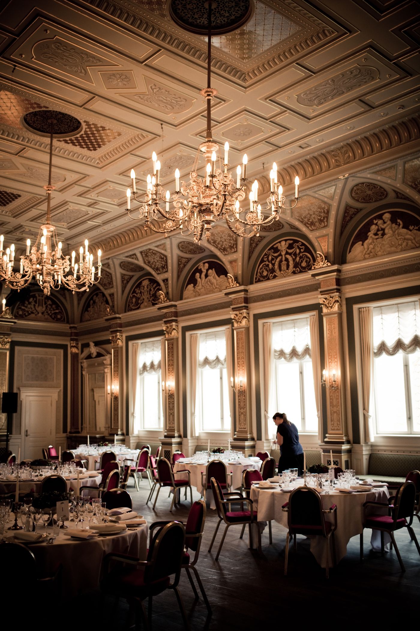 Luxurious classic restaurant dining room with chandeliers and an ornate ceiling