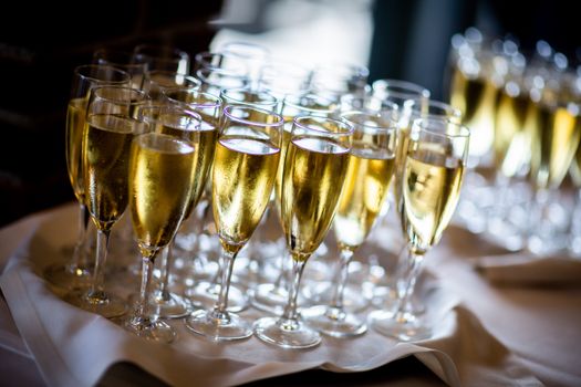Clear Wine Glasses with Gold Liquid on White Cloth Covered Table