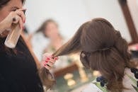 Woman Styling Hair of Customer