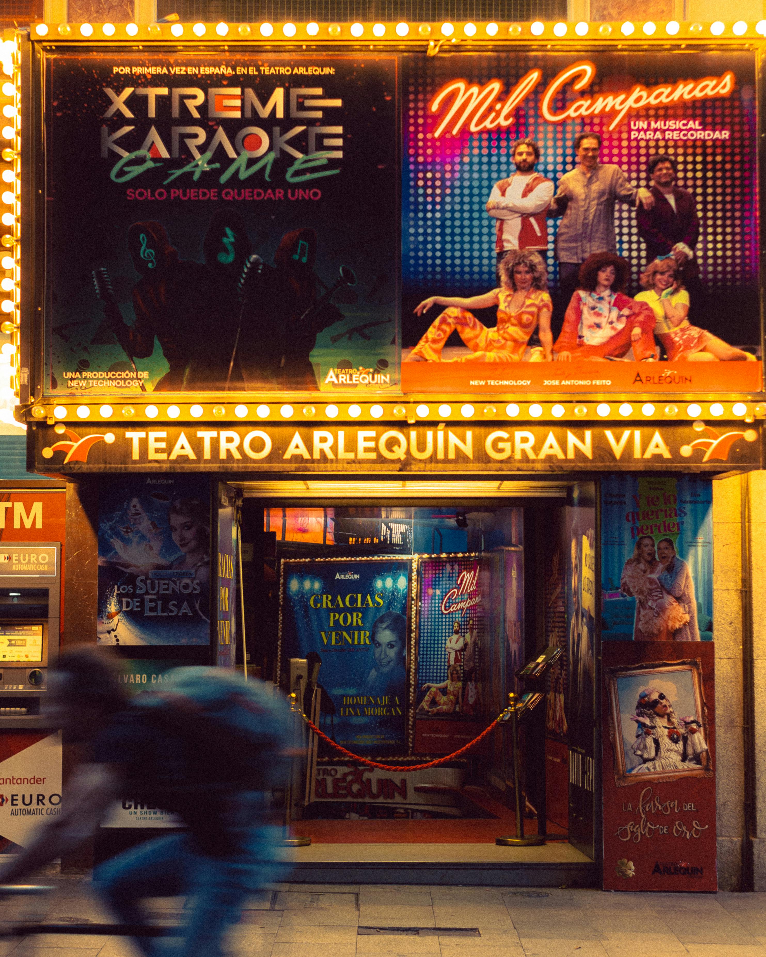 Free Capture the lively atmosphere outside Teatro Arlequín Gran Via, Madrid at night. Stock Photo
