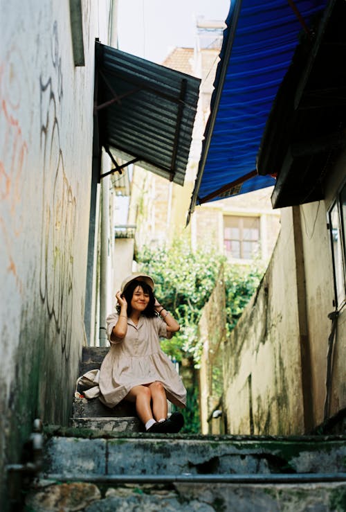 Photo of Woman Sitting While Wearing Dress