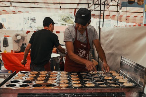 A man making pancakes at a food stand