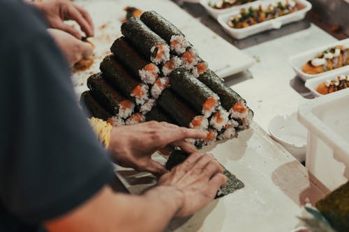 A person cutting sushi on a table