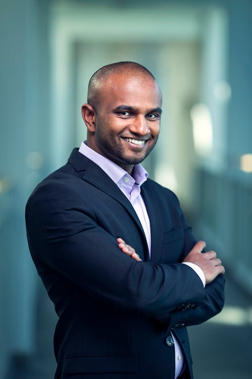 Man in Black Peaked Lapel Blazer Crossing Arms