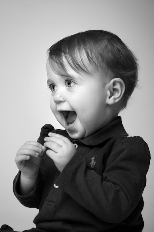 Grayscale Side View Portrait Photo of Happy Baby Boy in Ralph Lauren Polo Shirt 