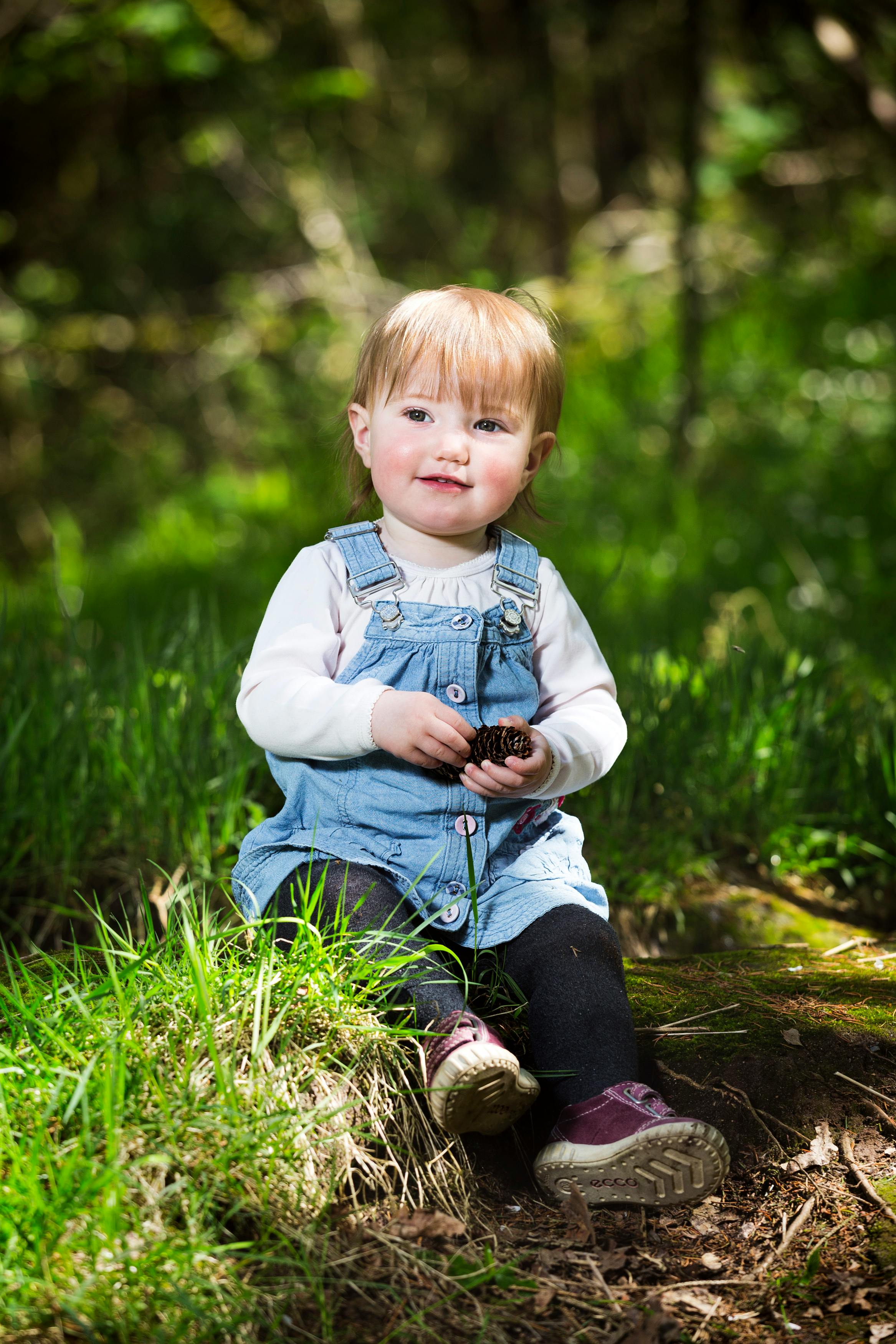 photo-of-baby-sitting-on-grass-free-stock-photo