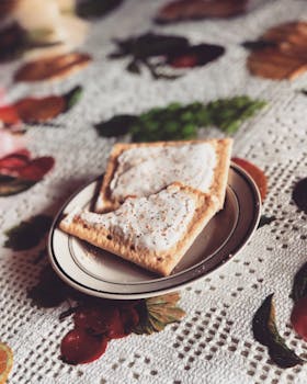 Warm breakfast scene featuring frosted pastries on a decorative tablecloth, perfect for cozy mornings.