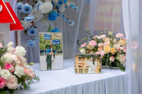 A table with flowers and pictures on it
