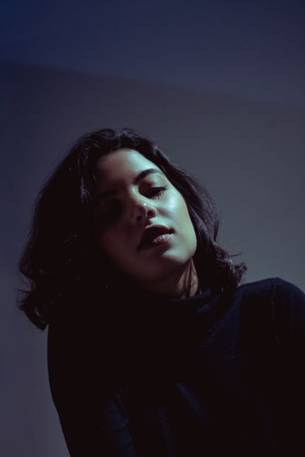 Artistic portrait of a woman with dramatic lighting, creating a mysterious mood.