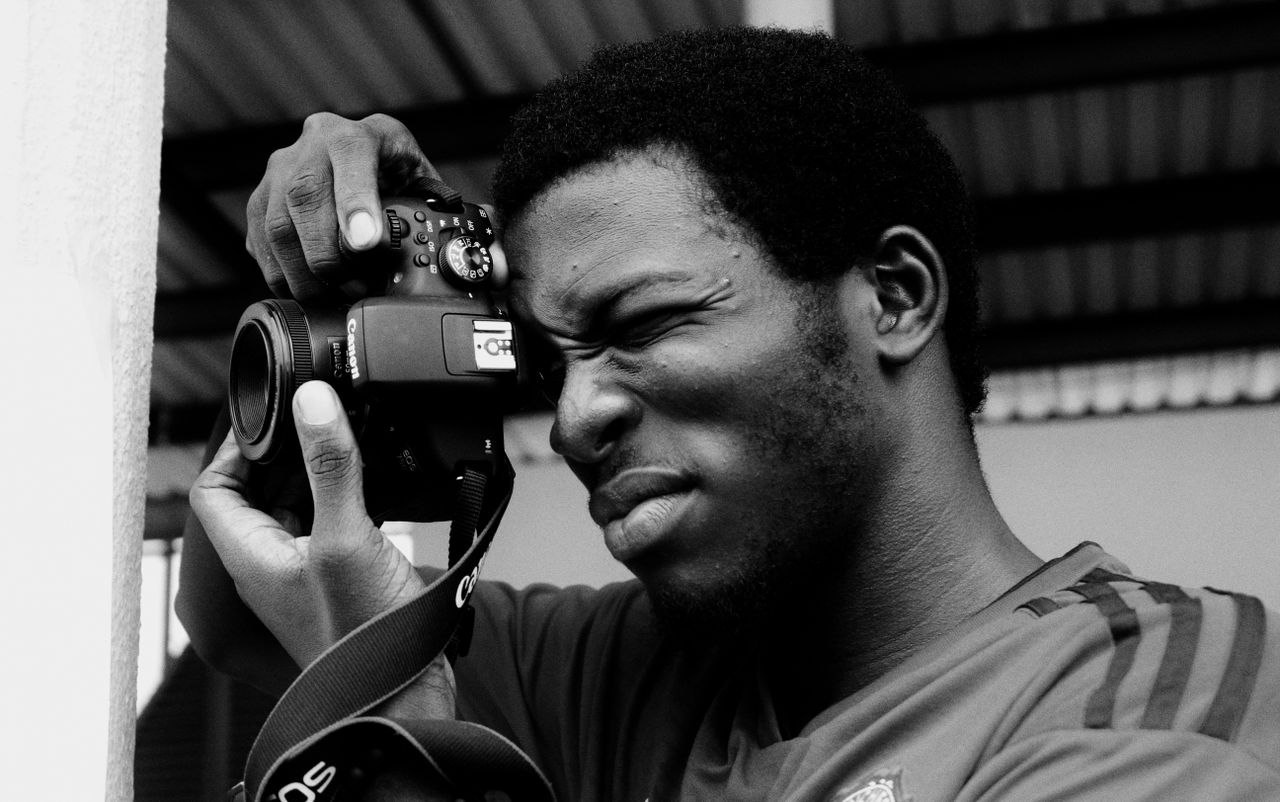 monochrome portrait of a man skillfully using a camera capturing a mom
