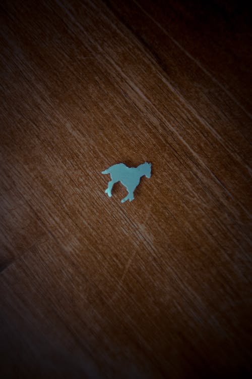 Blue Puzzle Piece on Brown Wooden Table