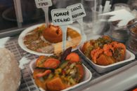 Close-up of acarajé and vegetarian options in a Brazilian display. Perfect for food lovers.