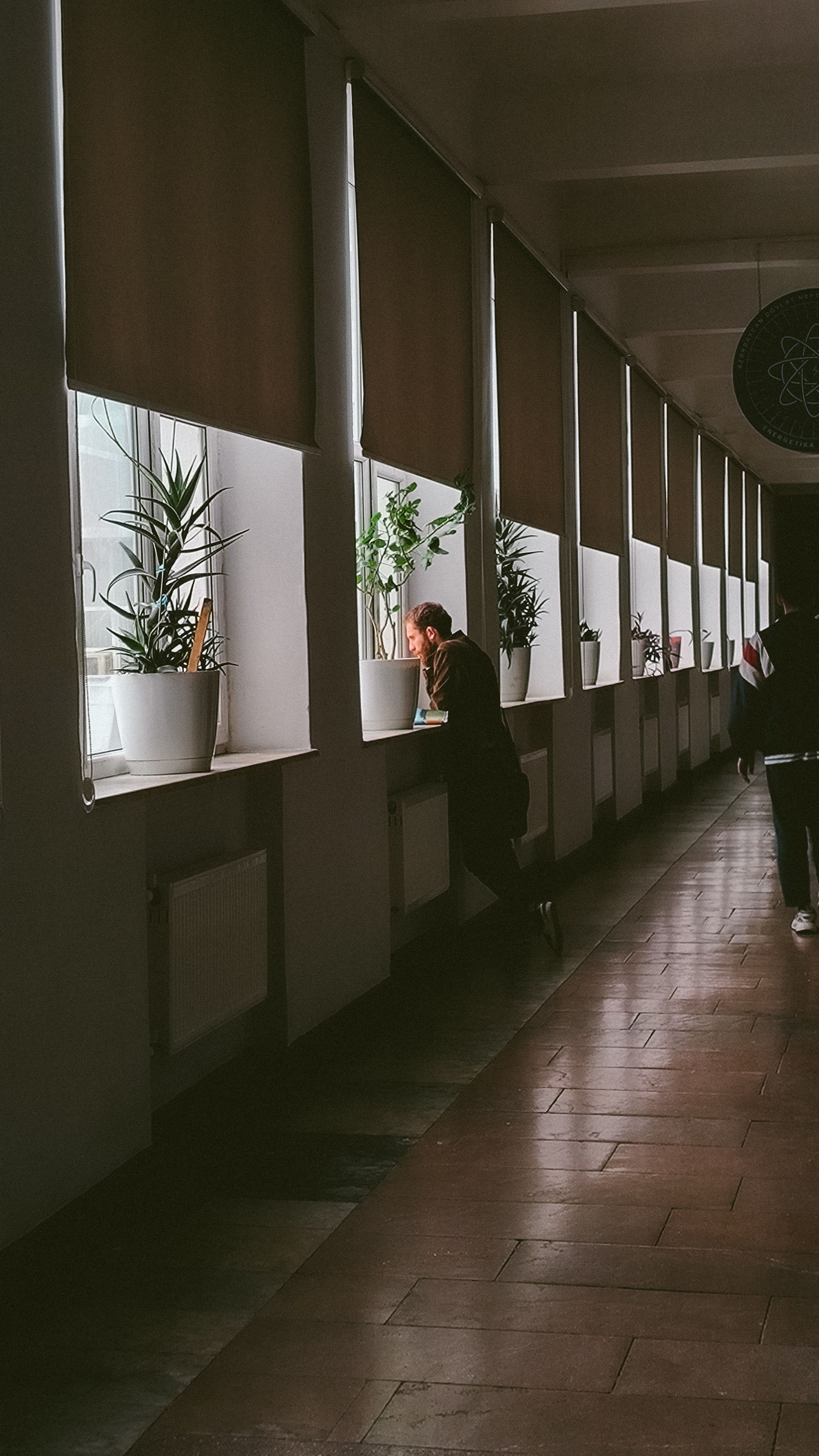 Man Standing near Windows