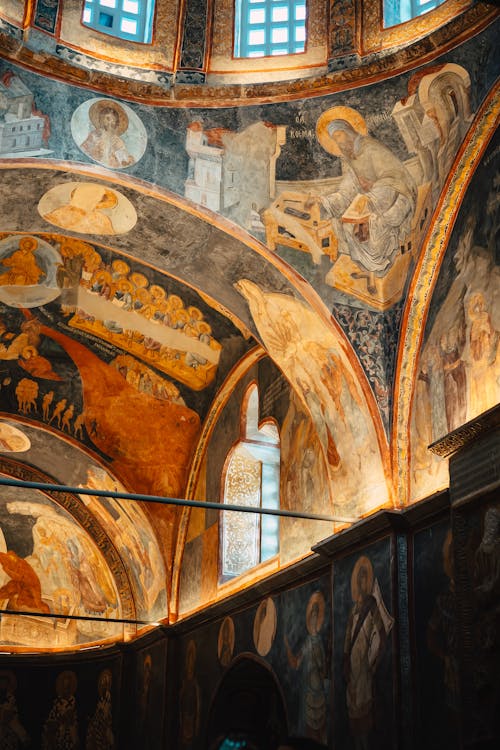 The inside of a church with paintings on the ceiling