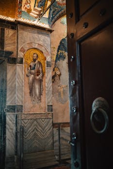 A detailed look at orthodox religious art inside a church with a focus on ornate wall paintings.