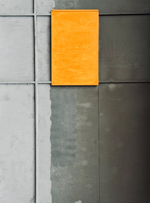 A yellow square on a gray wall