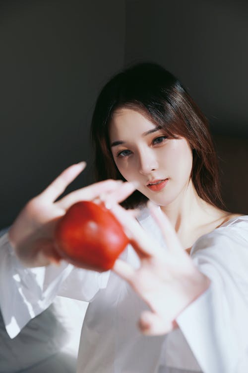 A woman holding an apple in her hand