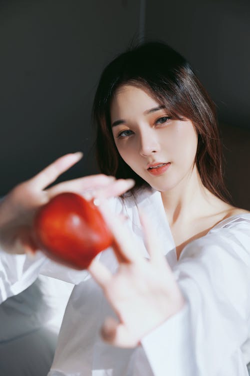 A woman holding an apple in her hand