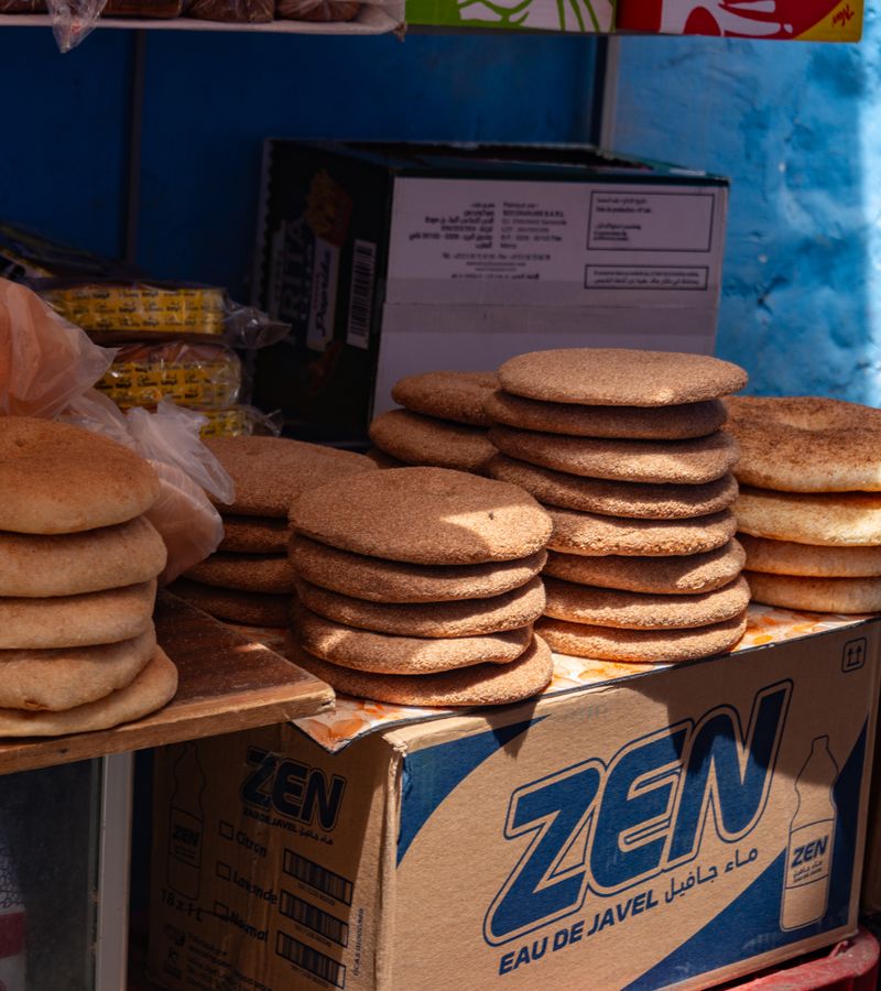 Baker pulling bread from the oven